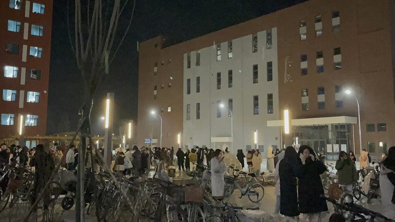 STUDENTS GATHER AFTER EVACUATING FROM THEIR DORMITORIES AT LANZHOU UNIVERSITY YUZHONG IN NORTHWESTERN CHINA'S GANSU PROVINCE, DECEMBER 19, 2023 © WANG XI VIA AP