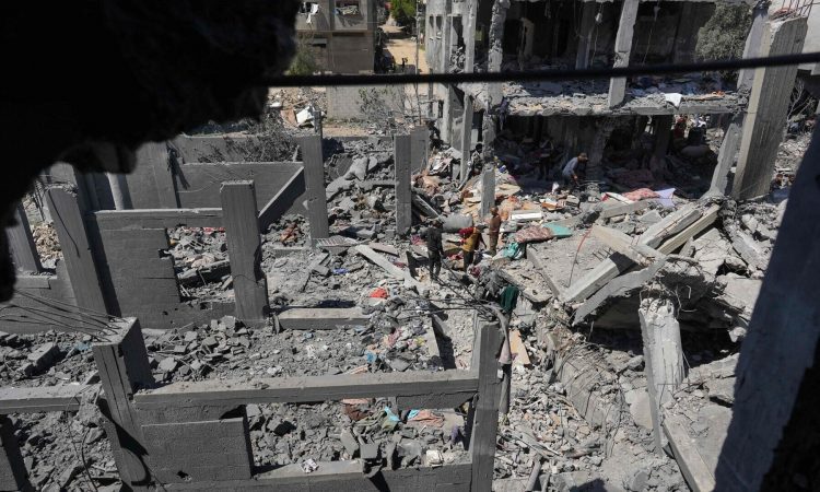PALESTINIANS INSPECT THE RUBBLE FOLLOWING OVERNIGHT ISRAELI BOMBARDMENT AT THE NUSEIRAT REFUGEE CAMP IN THE CENTRAL GAZA STRIP ON MARCH 20, 2024. — AFP