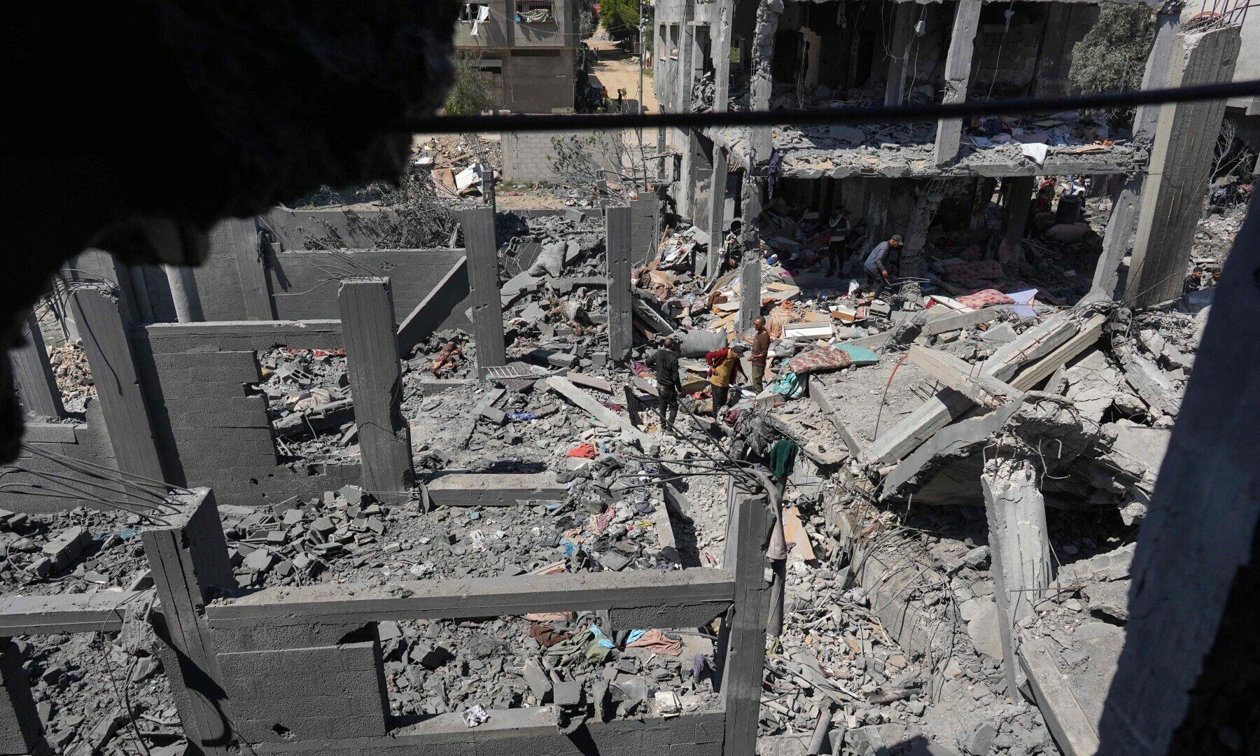 PALESTINIANS INSPECT THE RUBBLE FOLLOWING OVERNIGHT ISRAELI BOMBARDMENT AT THE NUSEIRAT REFUGEE CAMP IN THE CENTRAL GAZA STRIP ON MARCH 20, 2024. — AFP