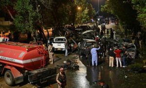 Security officials examine at the site of an explosion which occured near Karachi airport in Karachi, on late Oct 6, 2024. — AFP